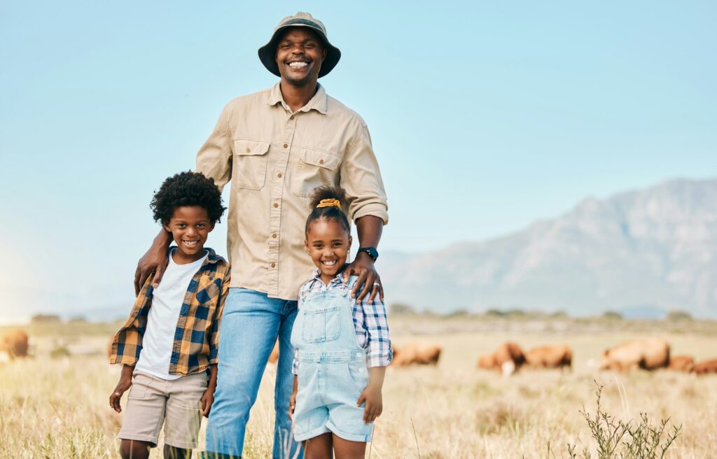 Family, portrait and people with animals in nature on holiday, travel and adventure in safari. Afri